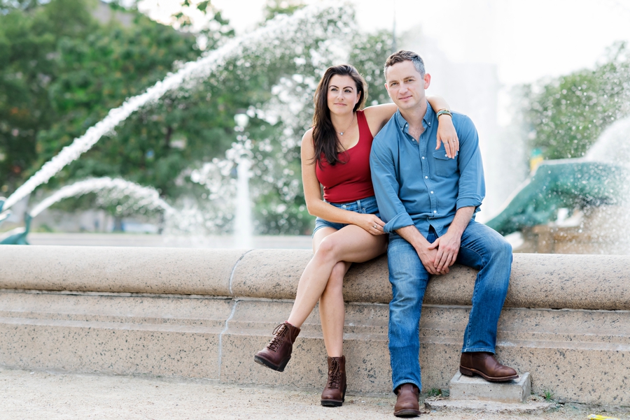 A cool couple sit on the edge of a fountain in Logan Circle.